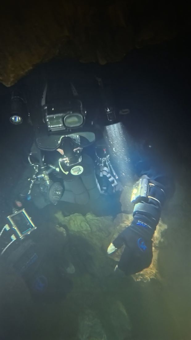 A narrow cave passage in torchlight