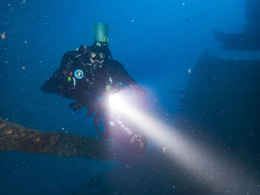 A wreck lit up by a dive light