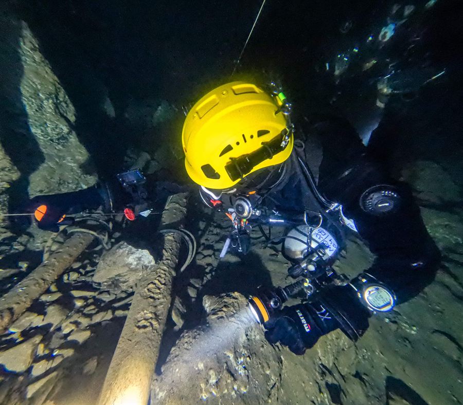 Close-up on a cave dive with helmet and light